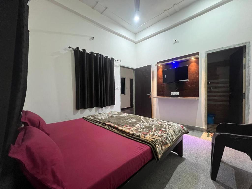 a bedroom with a red bed in a room at Bajrang seva dham in Mathura