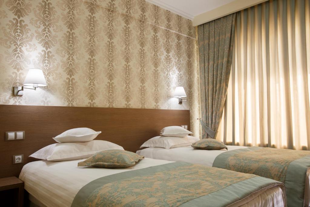 Postel nebo postele na pokoji v ubytování Hotel Stil