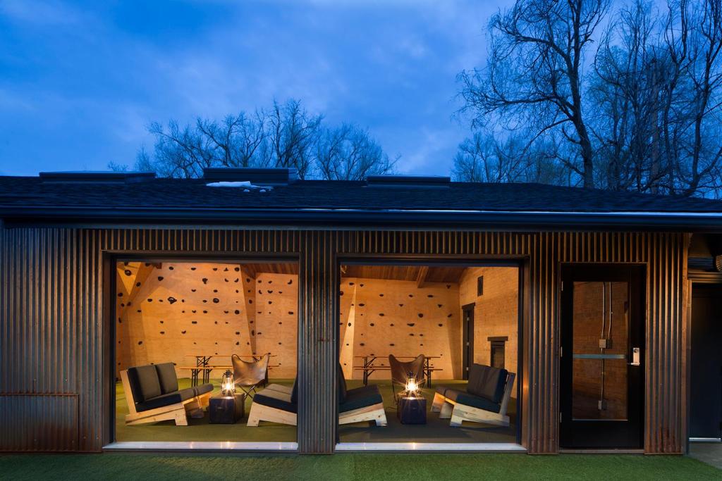 a screened in porch of a house with chairs and lights at Basecamp Boulder in Boulder