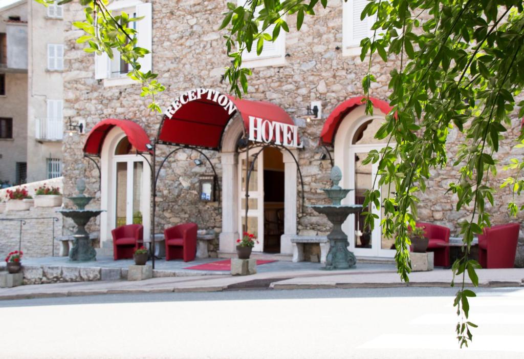 a building with a hino sign in front of it at Hôtel U Palazzu & Spa in Venaco