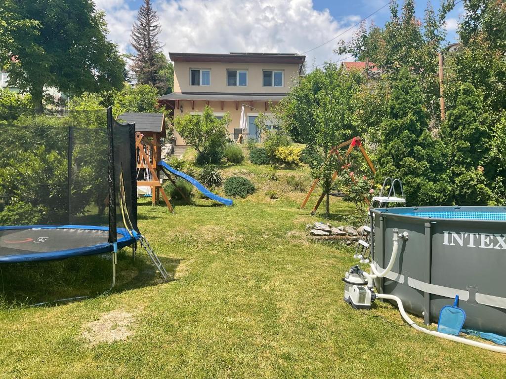 a yard with a trampoline and a playground at Sárkány Apartman és Vendégház Miskolctapolca in Miskolctapolca