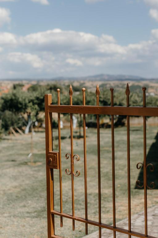 a metal fence with a view of a field at Casa Natura in Kilkis