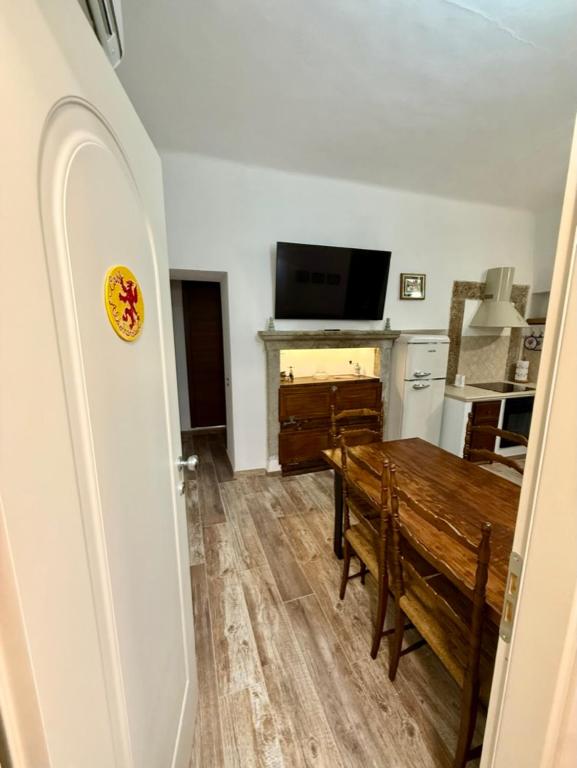 a living room with a dining room table and a television at CASA ALDOBRANDESCHI - Tuscan ToBe in Santa Fiora