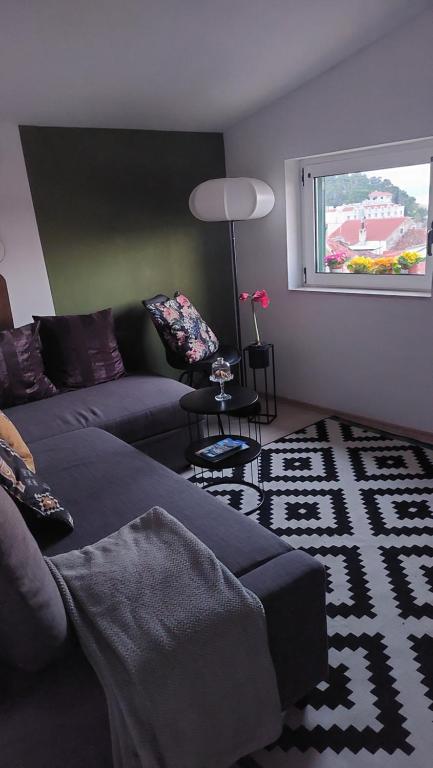 a living room with a couch and a window at San Marco Makarska in Makarska