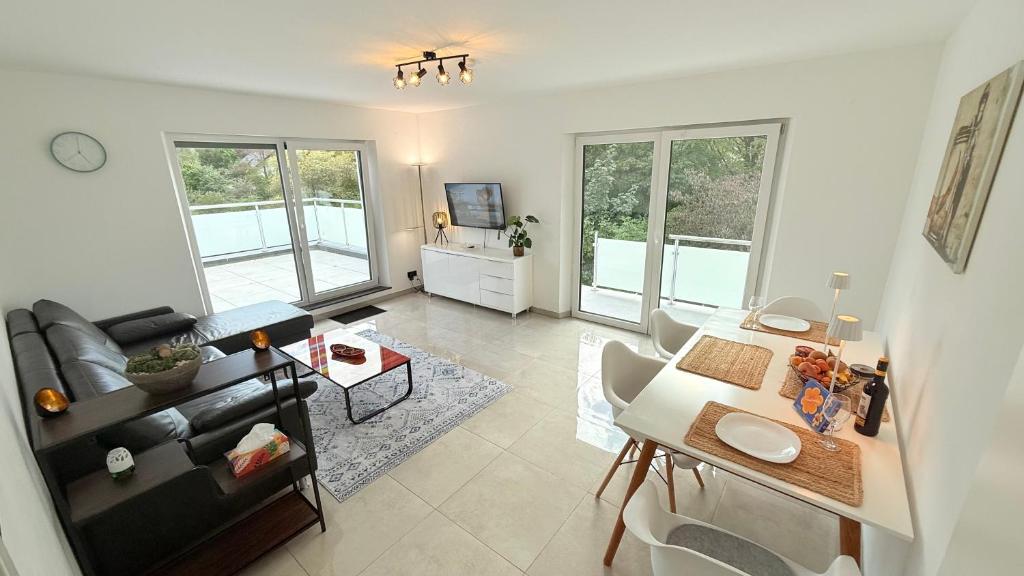 a living room with a couch and a table at Himy Home - Moderne Wohnung mit große Dachterrasse in Dormagen