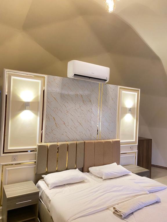 a bedroom with a large bed with a white bed sidx sidx sidx at Katy Camp Wadi Rum in Wadi Rum