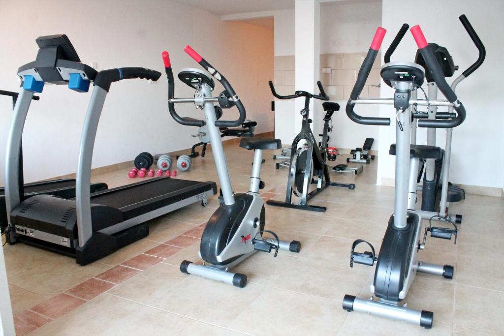 a gym with three exercise bikes and a treadmill at Apartments Villa Milna 1 in Budva