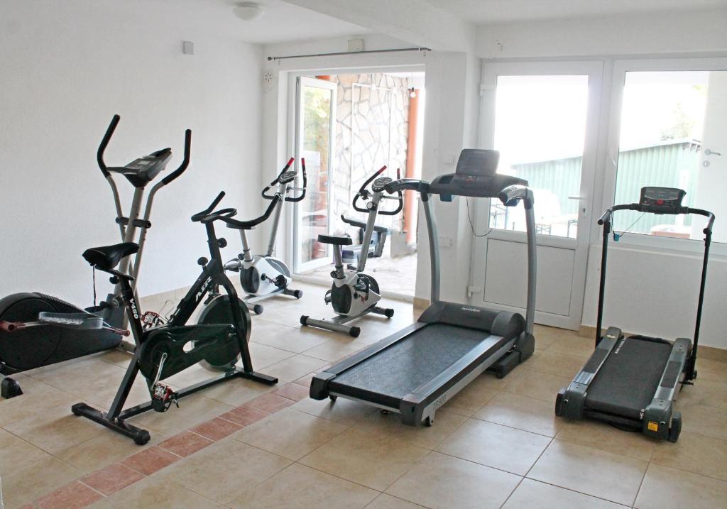 a gym with several exercise bikes in a room at Apartments Villa Milna 1 in Budva
