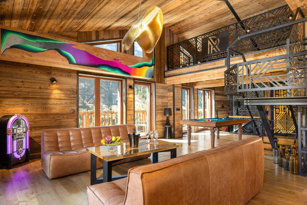a living room with a table and a pool table at Black Diamond - Tignes in Les Brévières