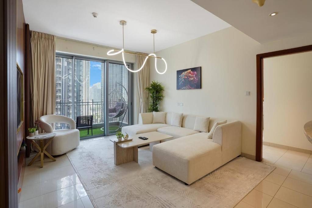 a living room with a couch and a table at 13Stnd- Luxury Living in Downtown Near Burj Khalifa & World Trade Center in Dubai