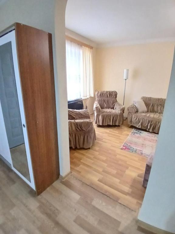 a living room with a door open to a living room at уют in Rustavi