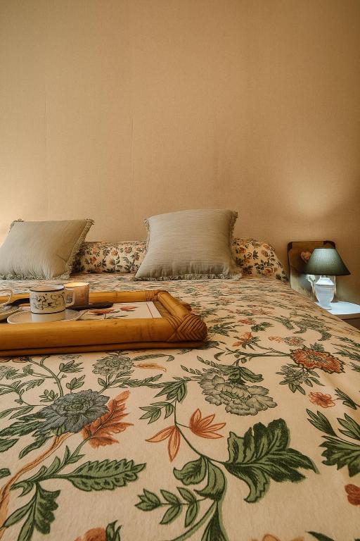 a large bed with a floral bedspread on it at Tina' S House in Cagliari
