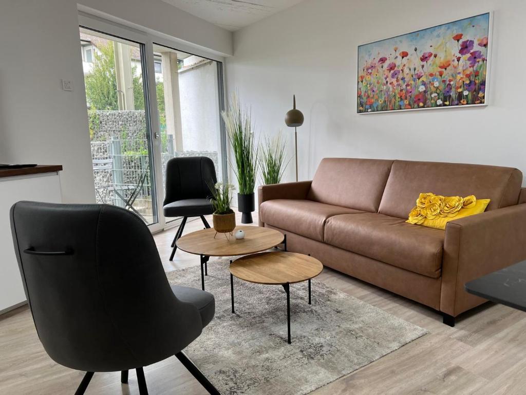 a living room with a couch and a table at NEU - Apartment in Brühl-City in Brühl