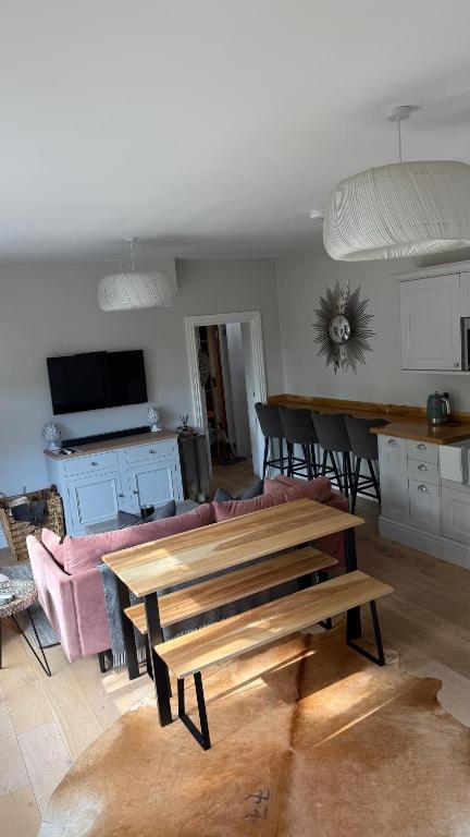 a living room with a couch and a table at Little Corners in Shawford
