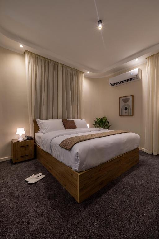 a bedroom with a large bed in a room at Welhome Stays Aparthotel in Cairo