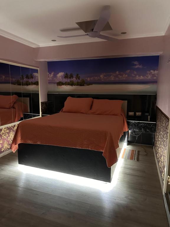 a bedroom with a large bed with a light on it at Hotel Santiago Yungay in Santiago