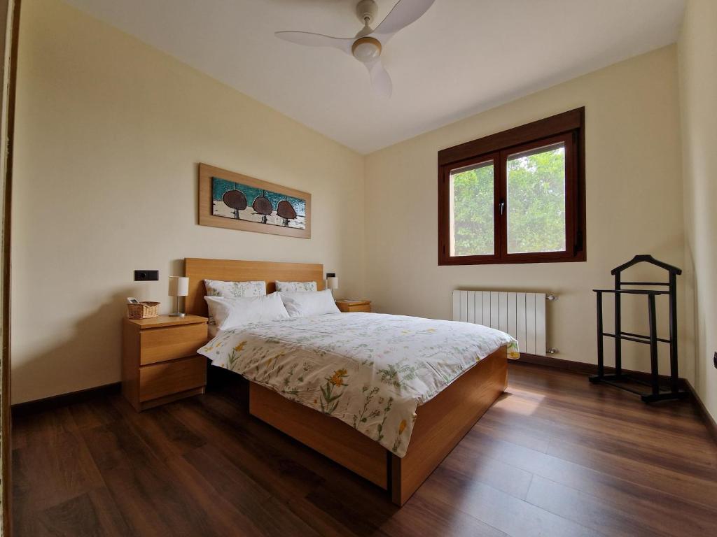 a bedroom with a bed and a window at "La Casa del Pueblo" - La Vera - AT-CC-00451 in Viandar de la Vera