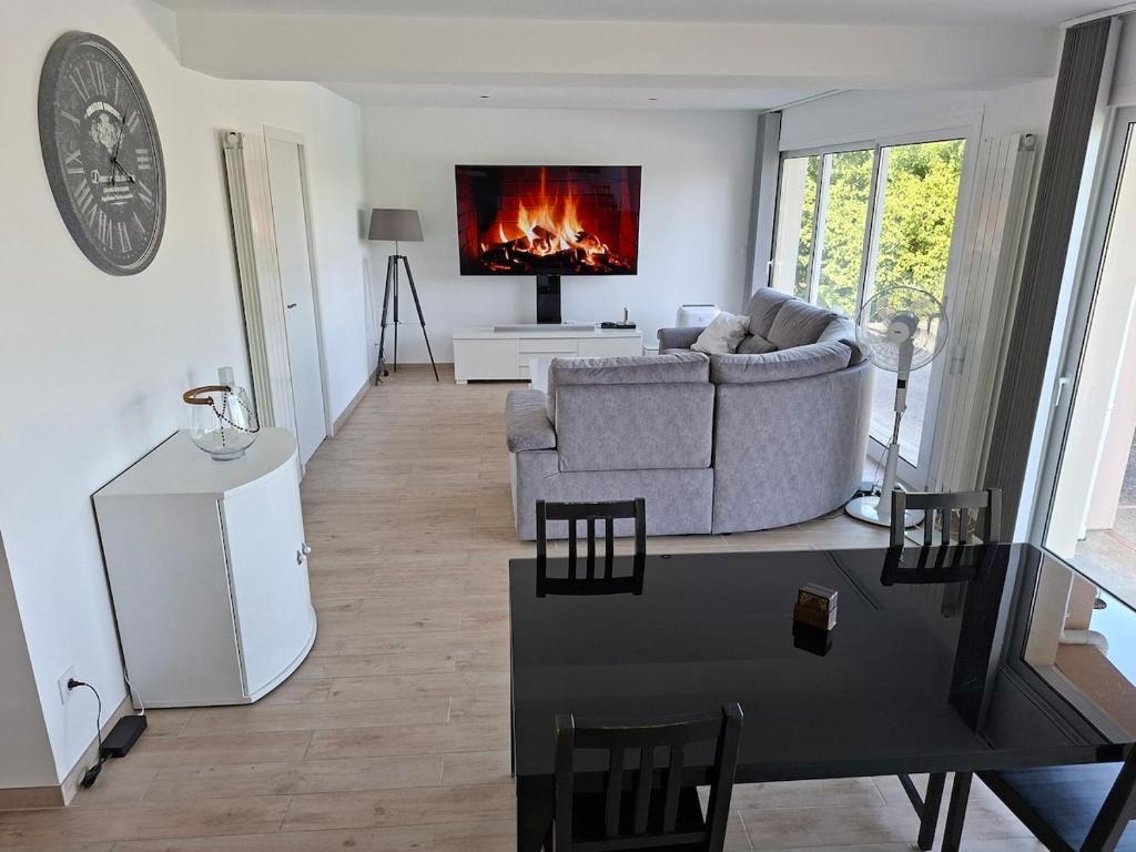 a living room with a couch and a fireplace at Belvédère du bonheur in Samatan