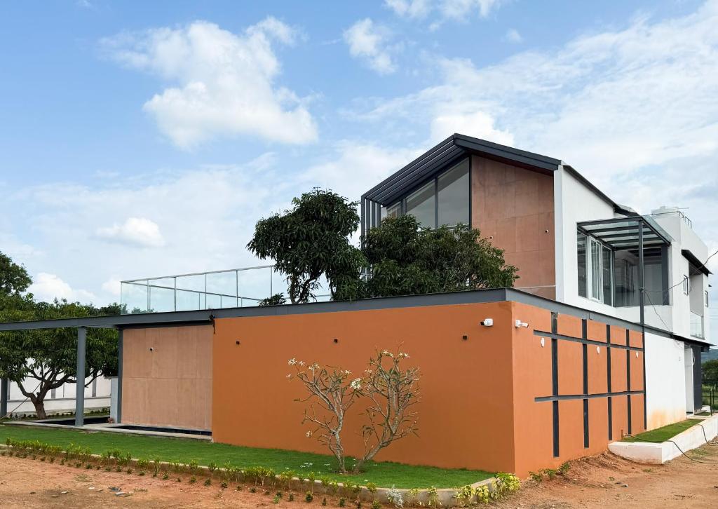 a modern house with orange and white at Red Apple Farm Villa by Mystic Hotels 
