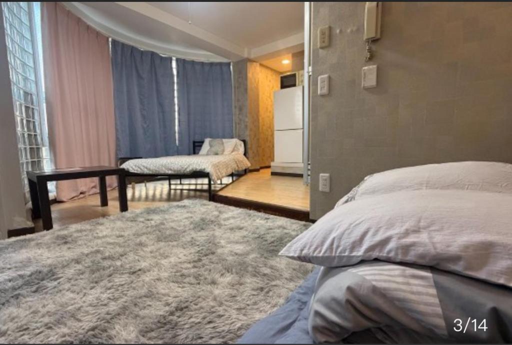 Ένα ή περισσότερα κρεβάτια σε δωμάτιο στο 大阪梅田西3a