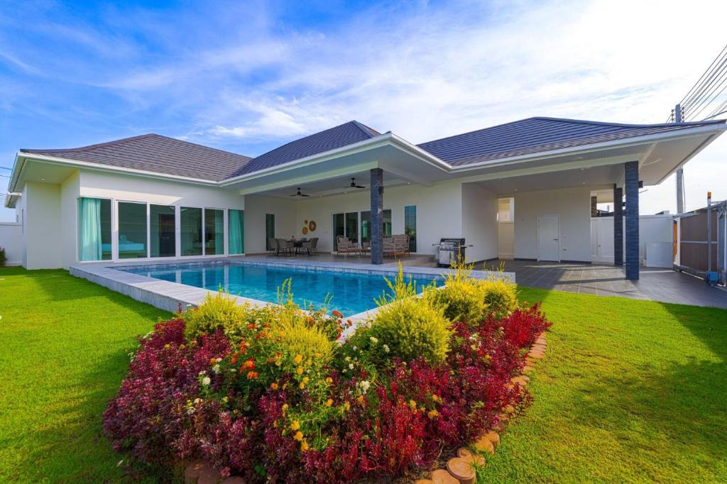 a house with a swimming pool in a yard at Modern 3 Bedroom Villa - AS1 in Hua Hin