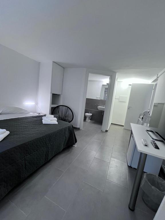 a hotel room with a bed and a bathroom at Residenza Margot Cosenza in Cosenza