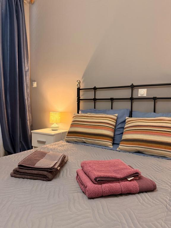 a bedroom with two towels on a bed at WINDSOR PLACE APARTMENT - SELF CHECKIN with CODE in Athens
