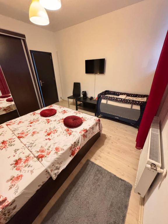 una camera da letto con un letto con cuscini rossi di Infinit Otopeni a Otopeni