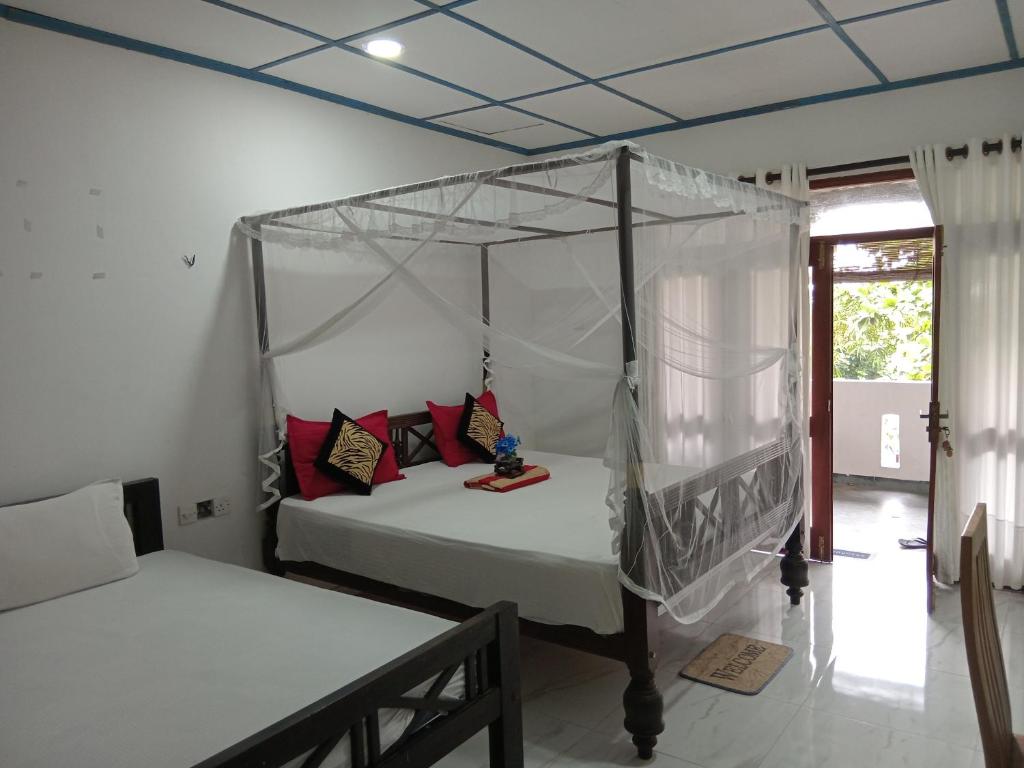 a bedroom with a bed with a canopy at Villa sea 40 Ambalangoda in Wenamulla