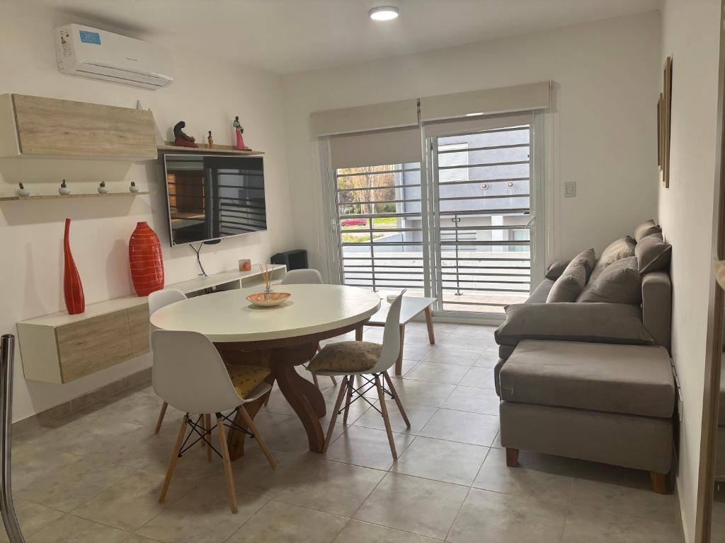 Una cocina y una sala de estar con una mesa y un sofá. en Departamento Castello -Viedma, en Viedma