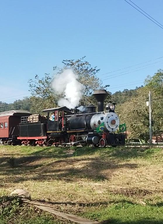 an old steam engine train traveling down the tracks at Casa Dona Flor in Morretes