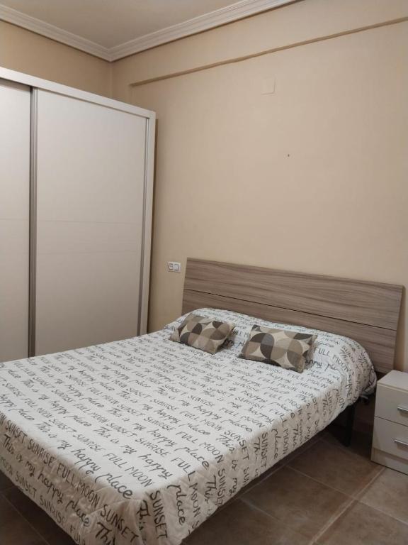 a bedroom with a bed with two pillows on it at Habitacion Luisa in Gandía