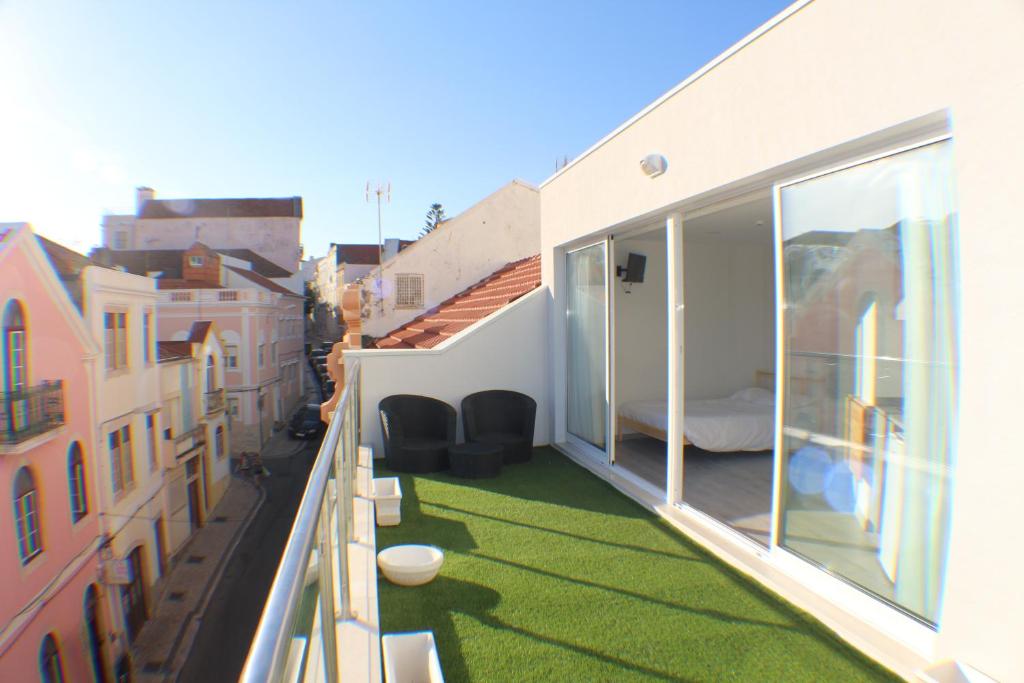 a balcony with green grass on the side of a building at Bike Suite in Figueira da Foz