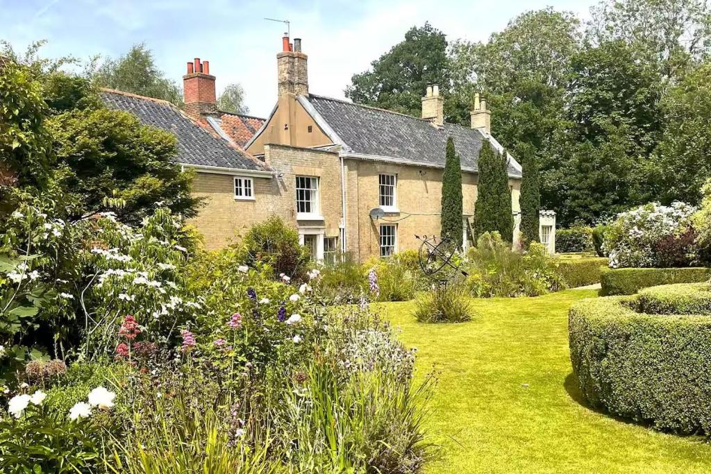 an old house with a garden in front of it at Beautiful Georgian Country House - Norfolk in Dilham