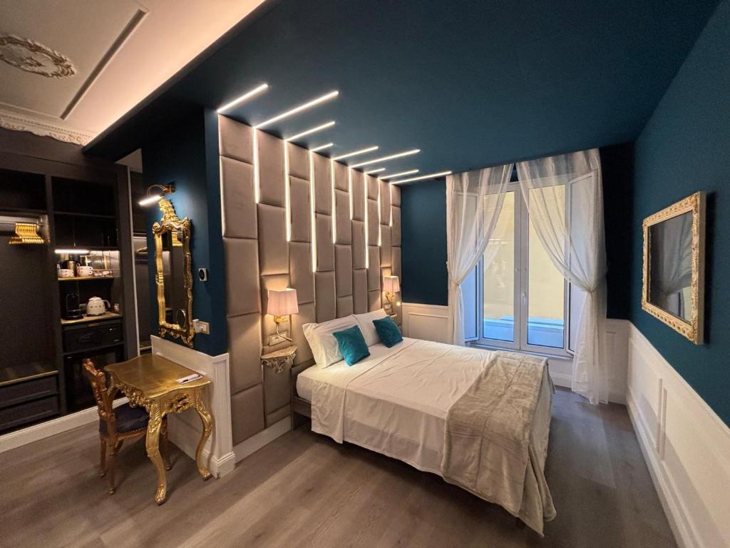 a bedroom with a bed and a blue wall at Lary's - San Pietro in Rome