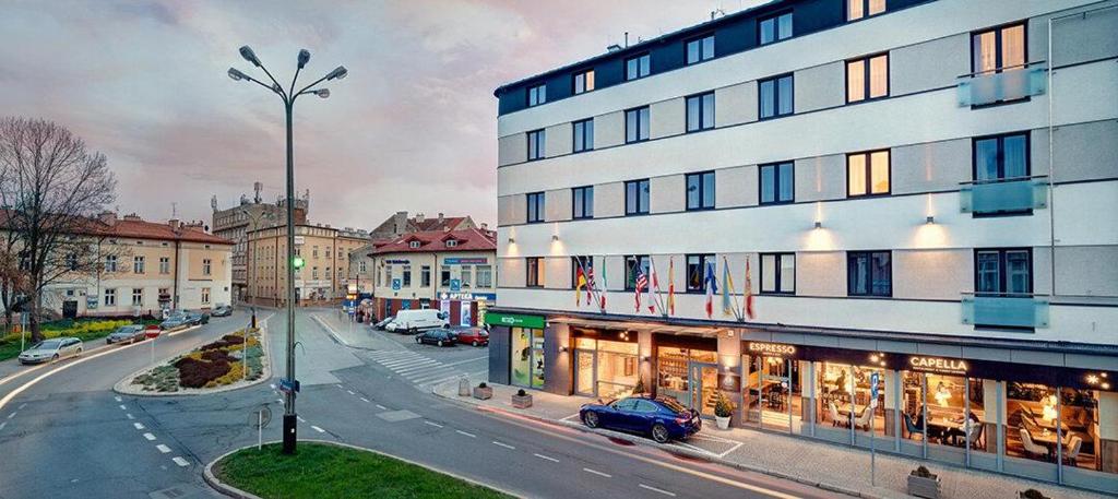 a building on a street with cars parked in front of it at B&B HOTEL RZESZÓW CENTRUM in Rzeszów
