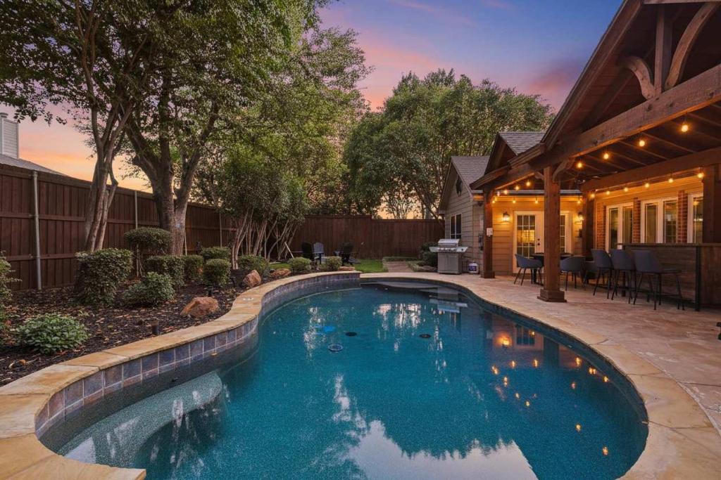 a swimming pool in the backyard of a house at 5BD 2BA w Backyard Oasis Pool Jacuzzi Firepit in Corinth