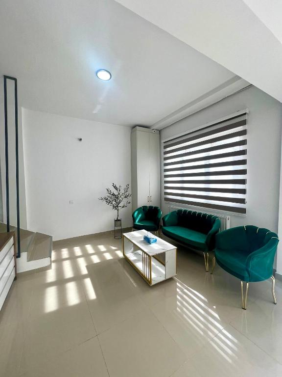 a living room with a couch and a table at AWA boutique in Voluntari