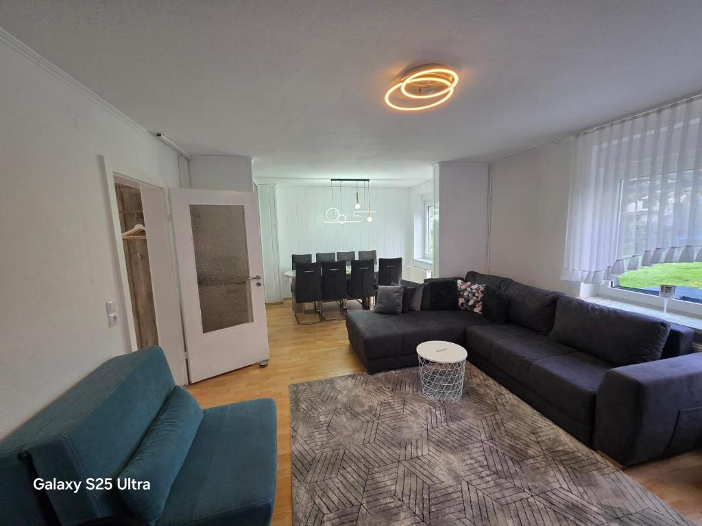 a living room with a couch and a table at MaiFerien Harz - Haus Goldstrahl in Clausthal-Zellerfeld