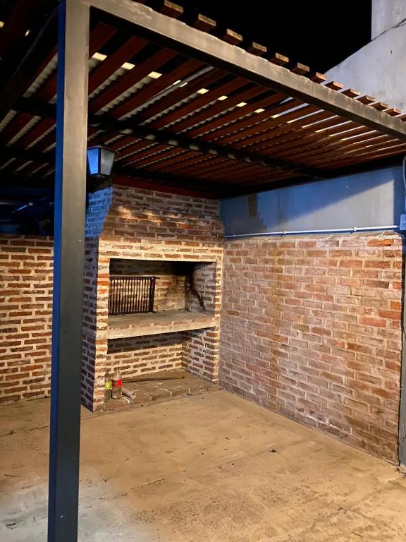 a brick walled room with a brick fireplace at La Tranquera 2 in La Paz