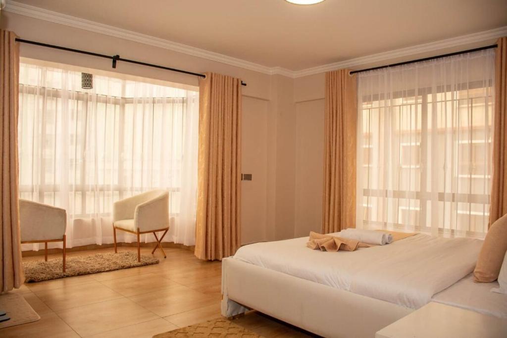 Postel nebo postele na pokoji v ubytování Dreamy Deluxe Apartment Nakuru