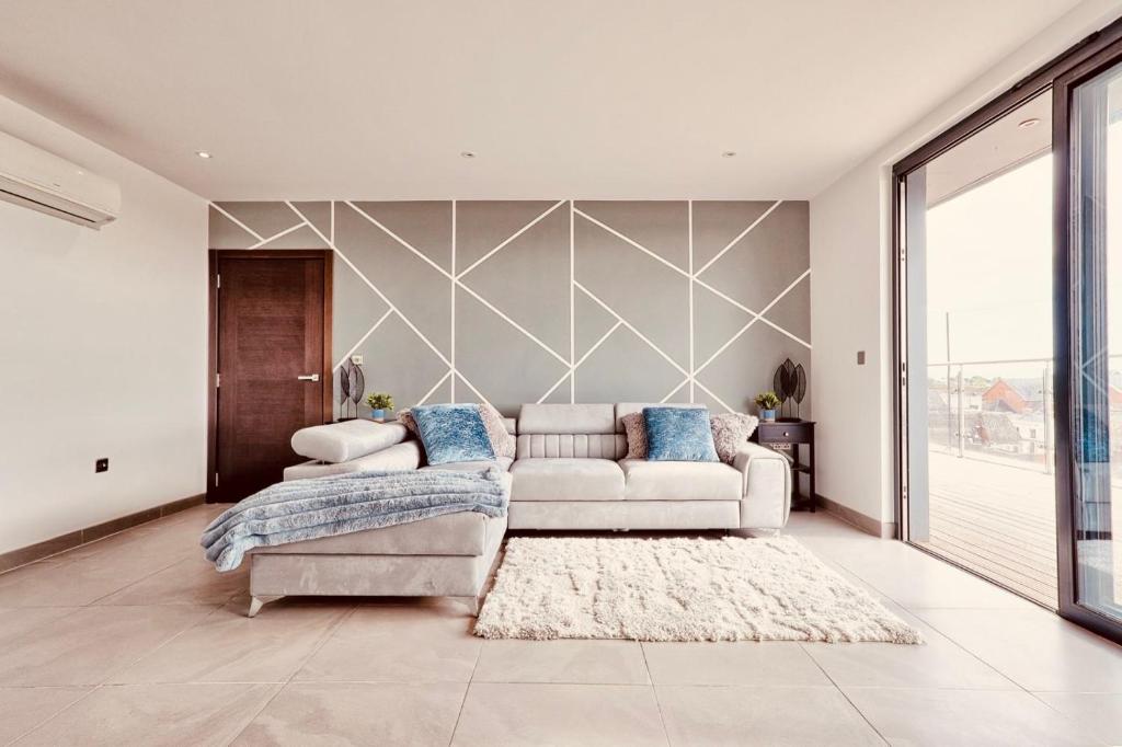 a living room with a couch and a rug at 2 Bed 2 Bath Penthouse in Chelmsford City Centre with Free Parking ideal for long stays and Contractors - sleeps 6 in Chelmsford