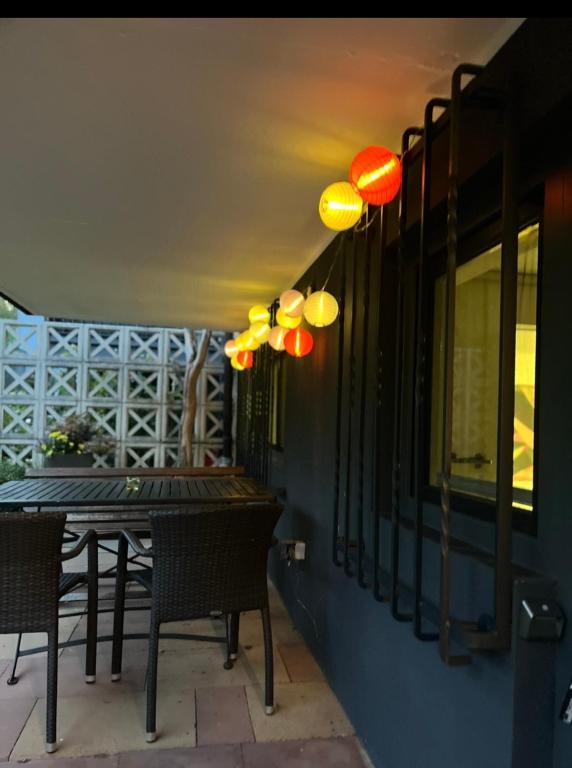 a table and chairs on a patio with lights at E11 Cologne in Cologne