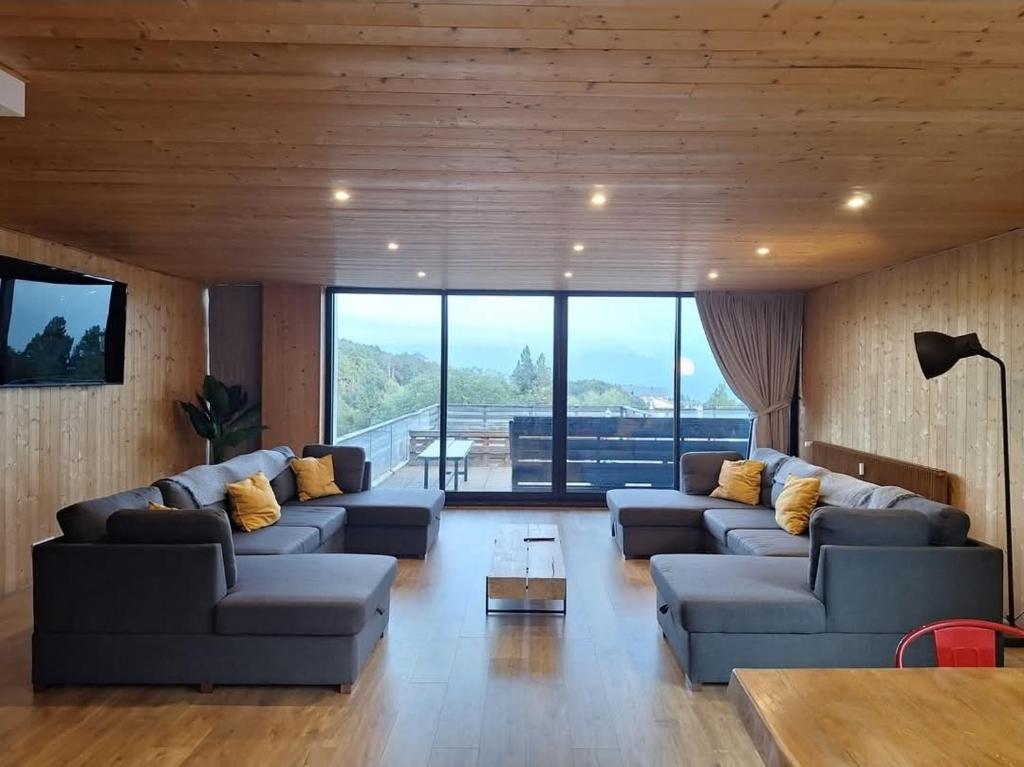 a living room with two couches and a table at Les terrasses du golf in Égat