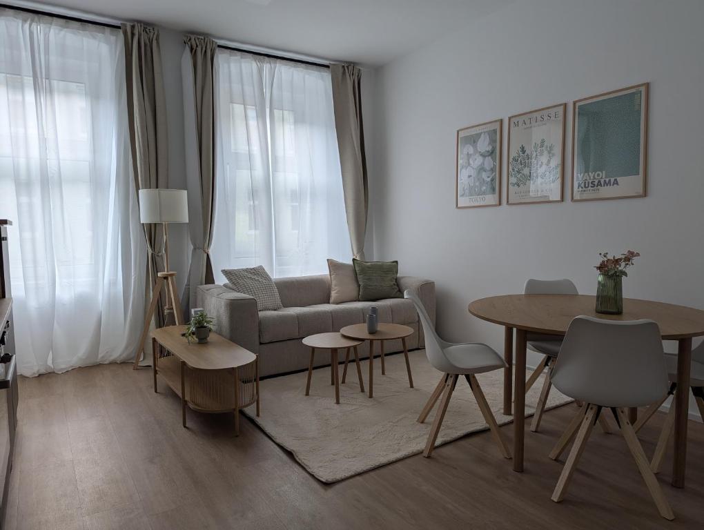 a living room with a couch and a table at Habicher Vienna Apartments in Vienna