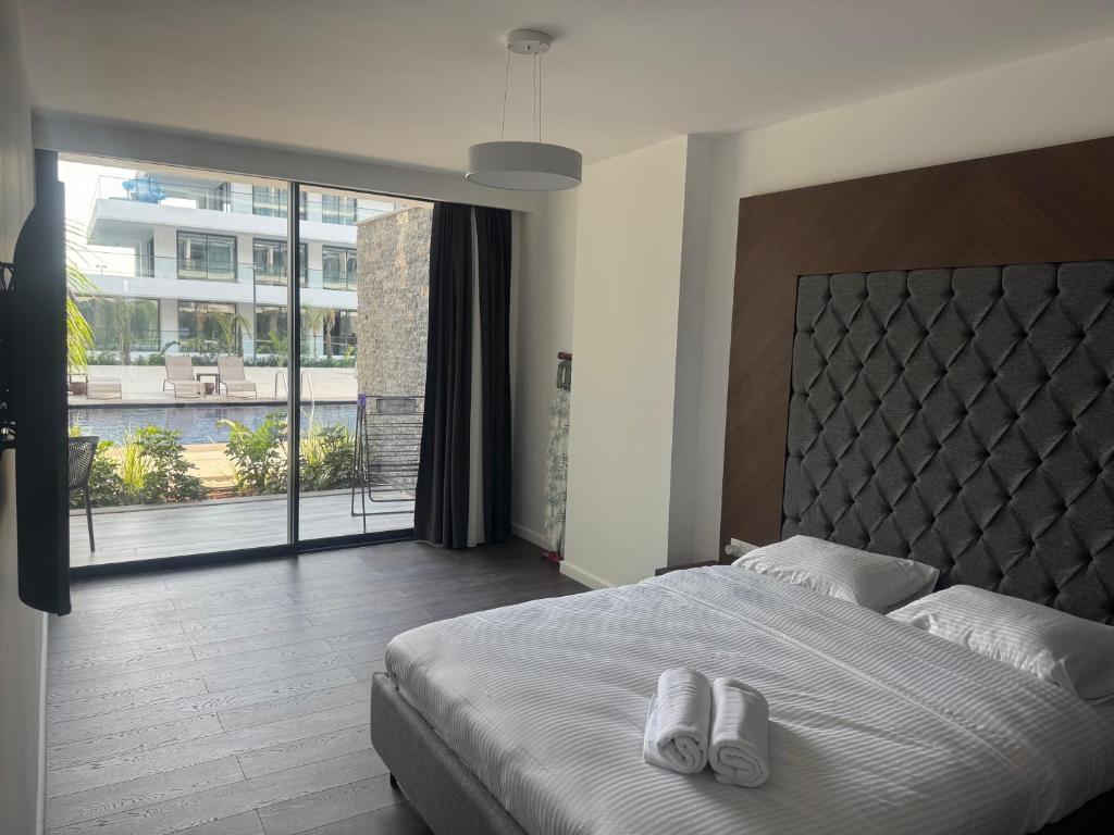 a bedroom with a large bed and a large window at Grand Sapphire Casino 12 in Iskele