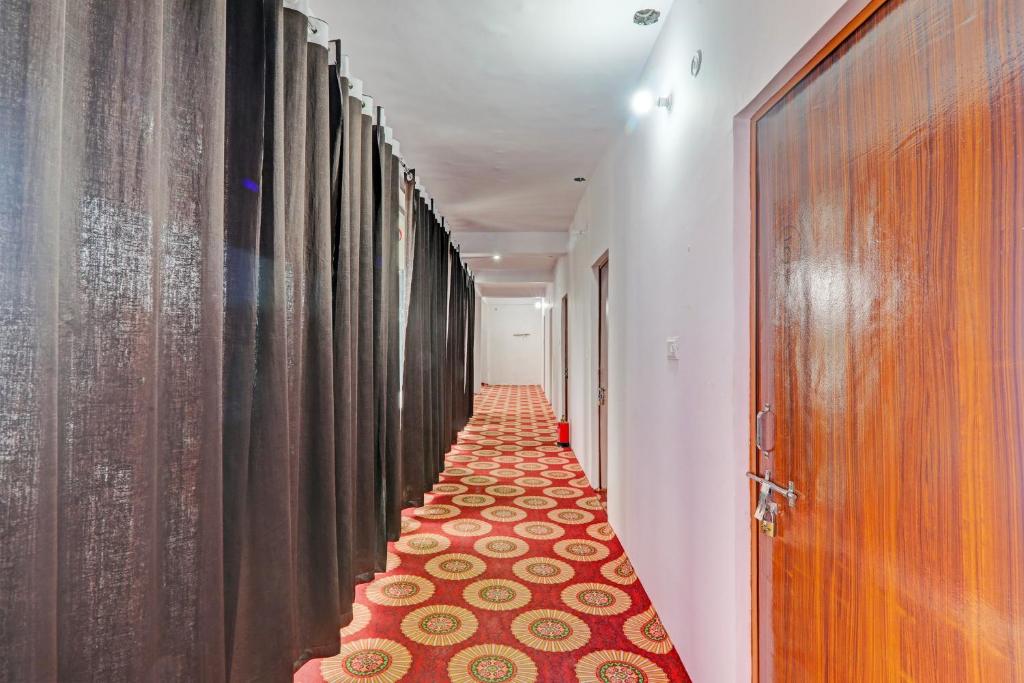 a hallway with a long corridor with curtains at Hotel O The Blue Heart in Itaunja