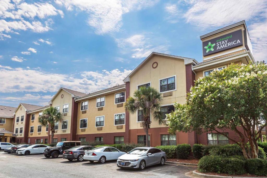 a hotel with cars parked in a parking lot at Extended Stay America Suites - Wilmington - New Centre Drive in Wilmington