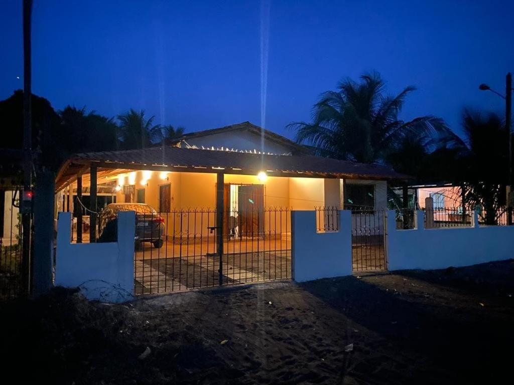 a fence in front of a house at night at Casa de Praia em Joanes - Salvaterra in Joanes