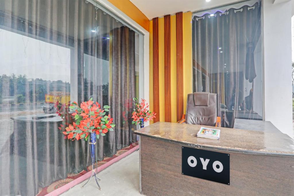 an office with a desk and a chair in front of a window at Hotel O The Blue Heart in Itaunja